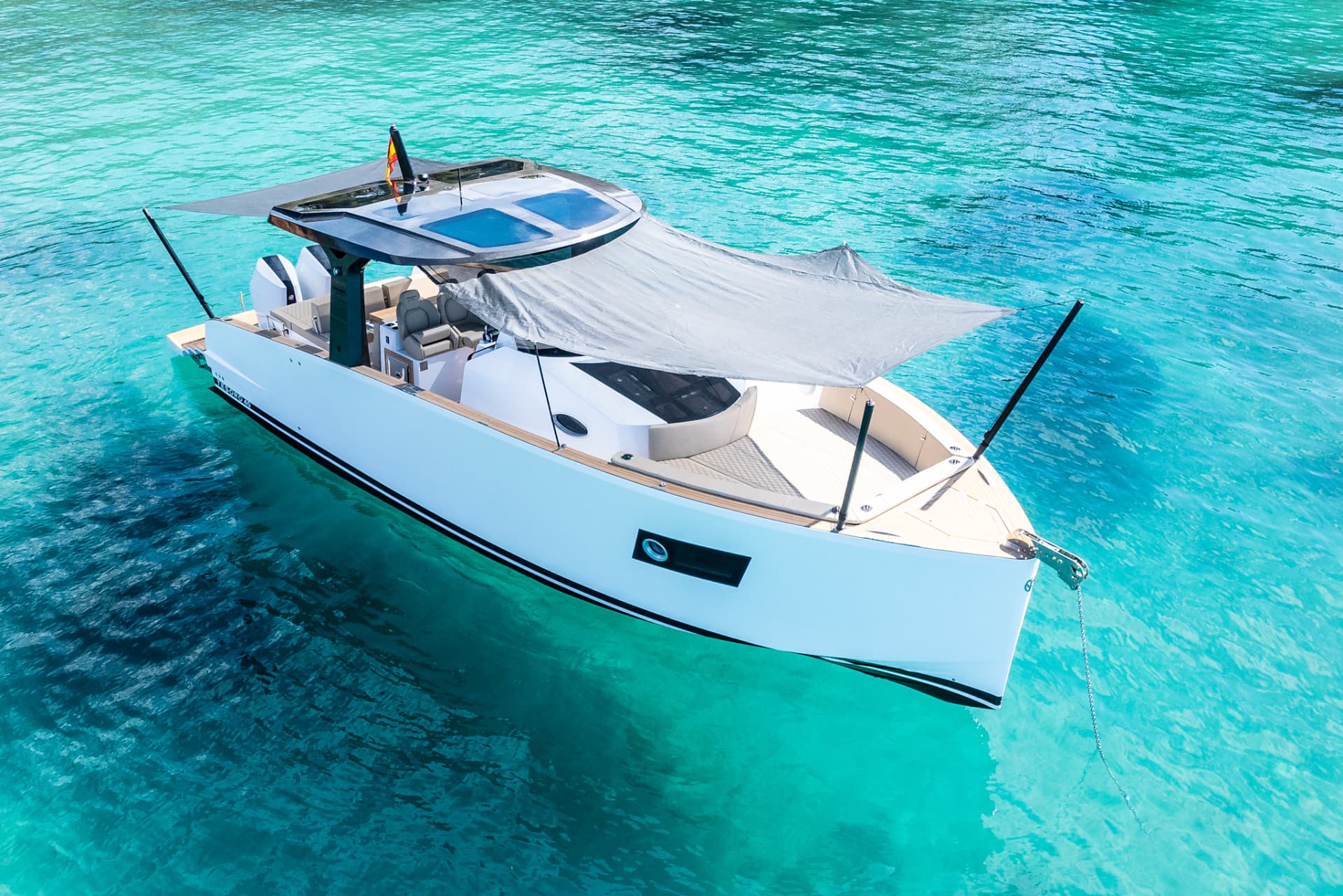 Tesoro T40 GTS New 2026 yacht charter in Mallorca — cockpit lounge shaded for long Mediterranean lunches, from Puerto Portals.