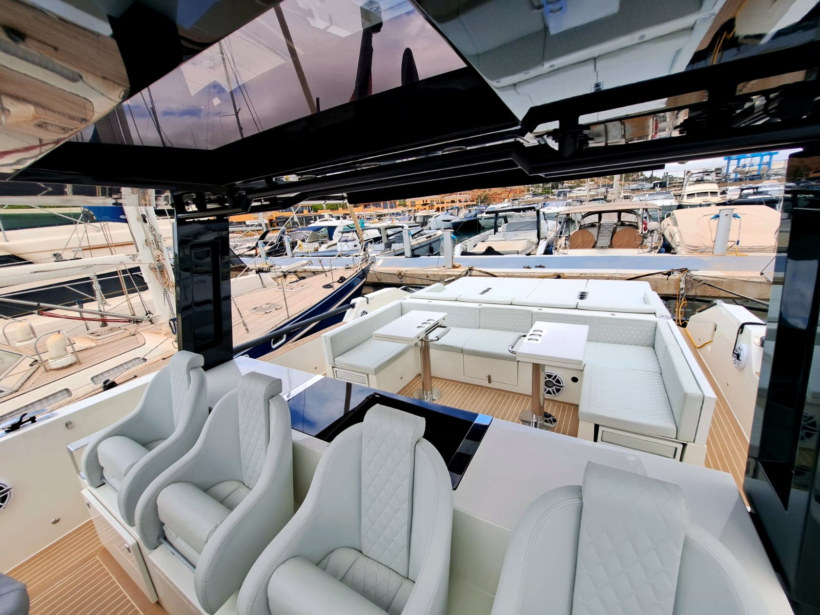 Shaded cockpit seating with soft cushions — the natural place for a long Mediterranean lunch.
