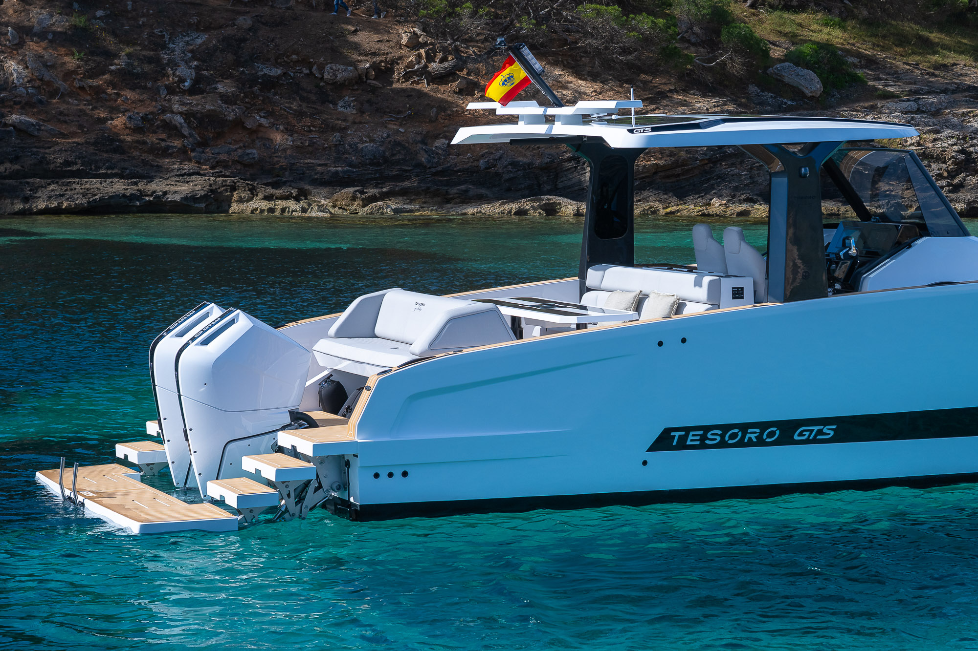 Tesoro T40 GTS New 2026 yacht charter in Mallorca — anchored in a turquoise cove near Puerto Portals, from Puerto Portals.