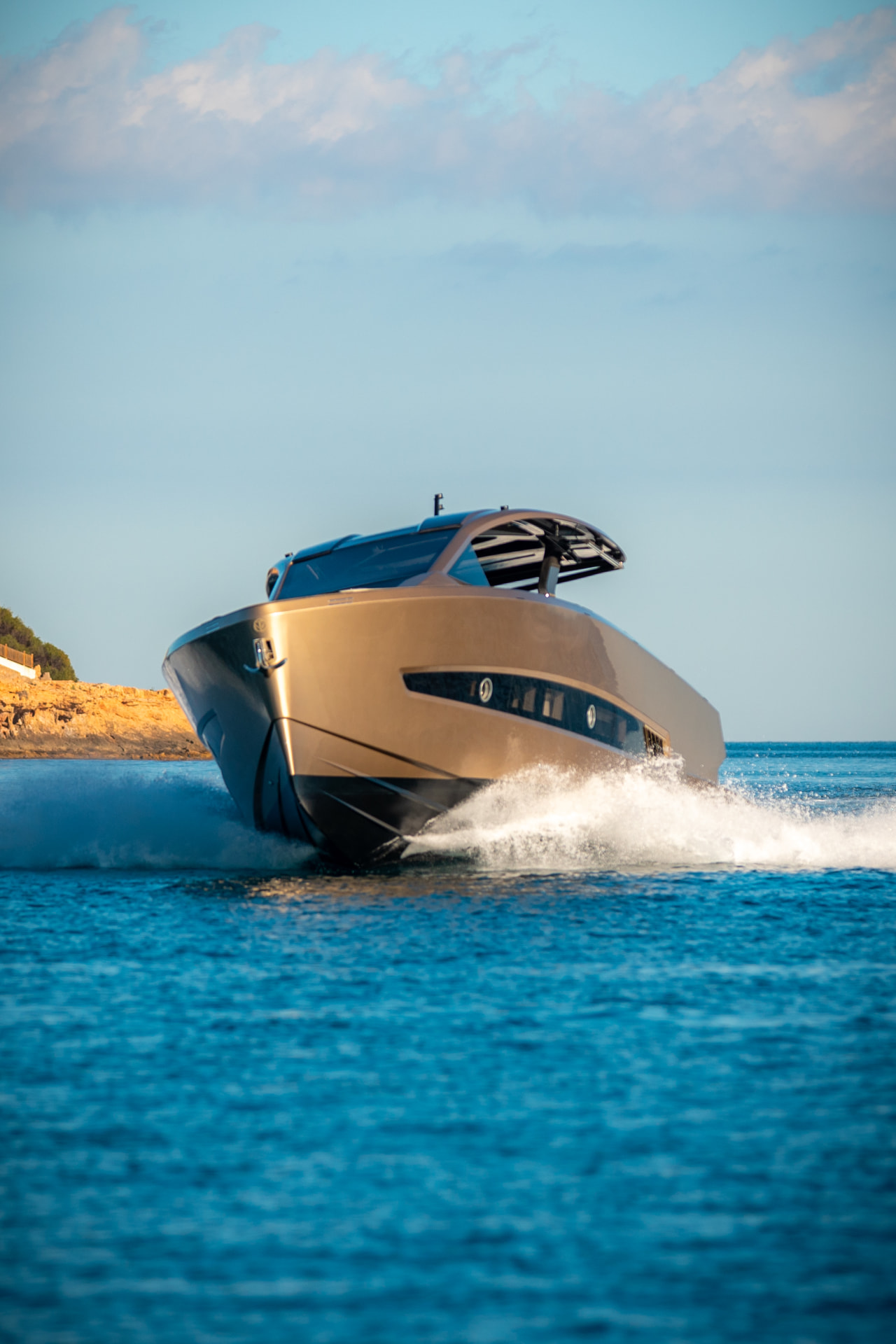 Tesoro T50 Speciale Goldfinger · Armani/Casa yacht charter in Mallorca — anchored in a turquoise cove near Puerto Portals, from Club de Mar, Palma.