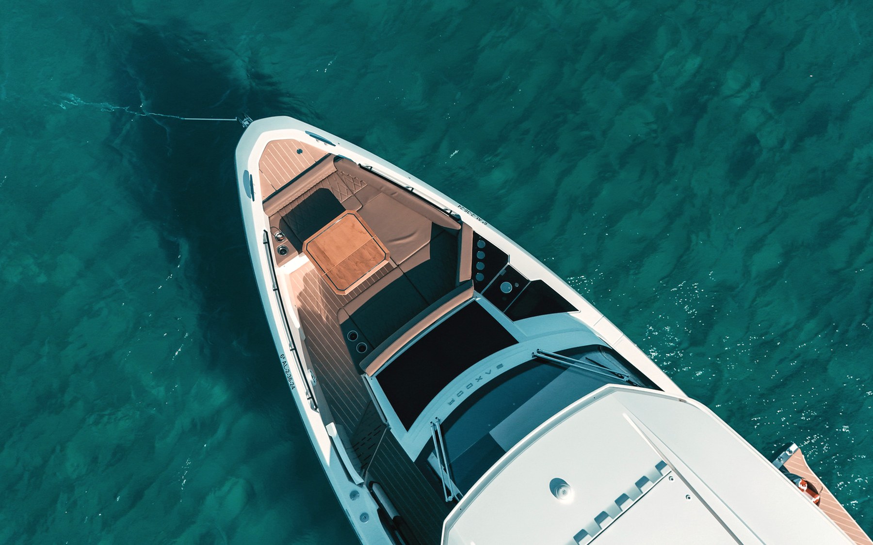Saxdor 400 GTO Bali yacht charter in Mallorca — anchored in a turquoise cove near Puerto Portals, from Marina Palma, La Lonja.