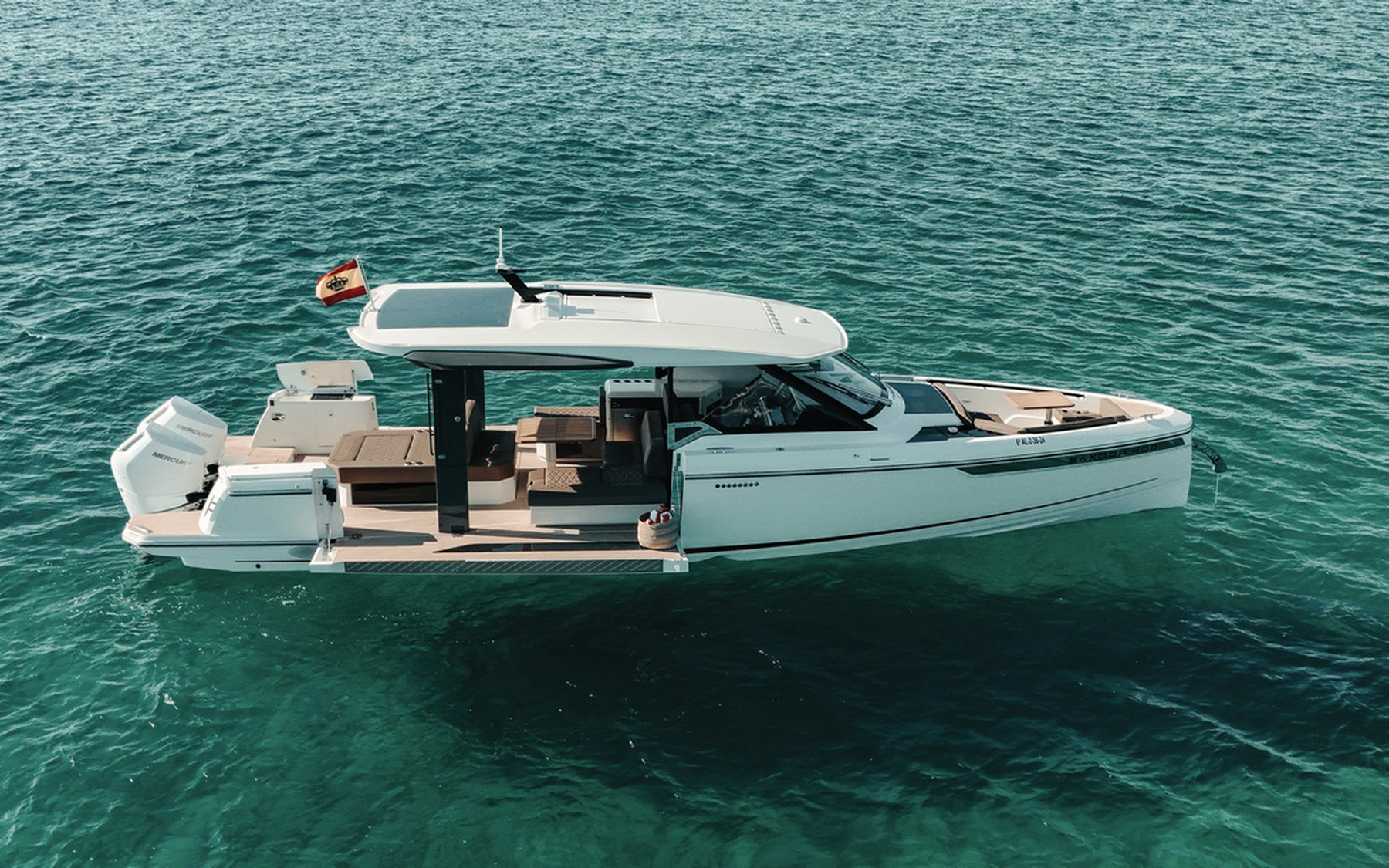 Saxdor 400 GTO Bali yacht charter in Mallorca — cockpit lounge shaded for long Mediterranean lunches, from Marina Palma, La Lonja.
