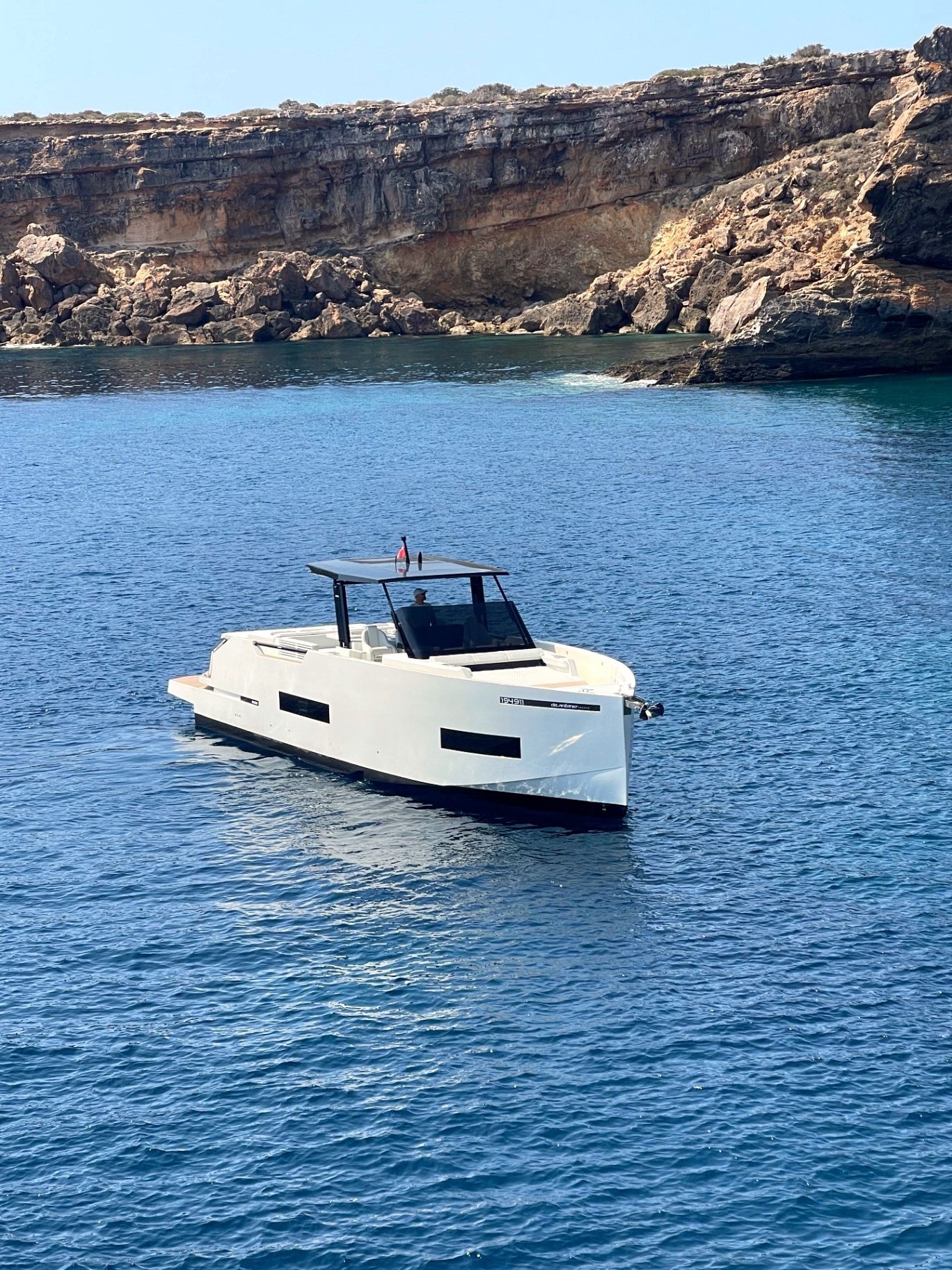 A quiet cove near Portals Vells with the yacht alone at anchor before lunch.