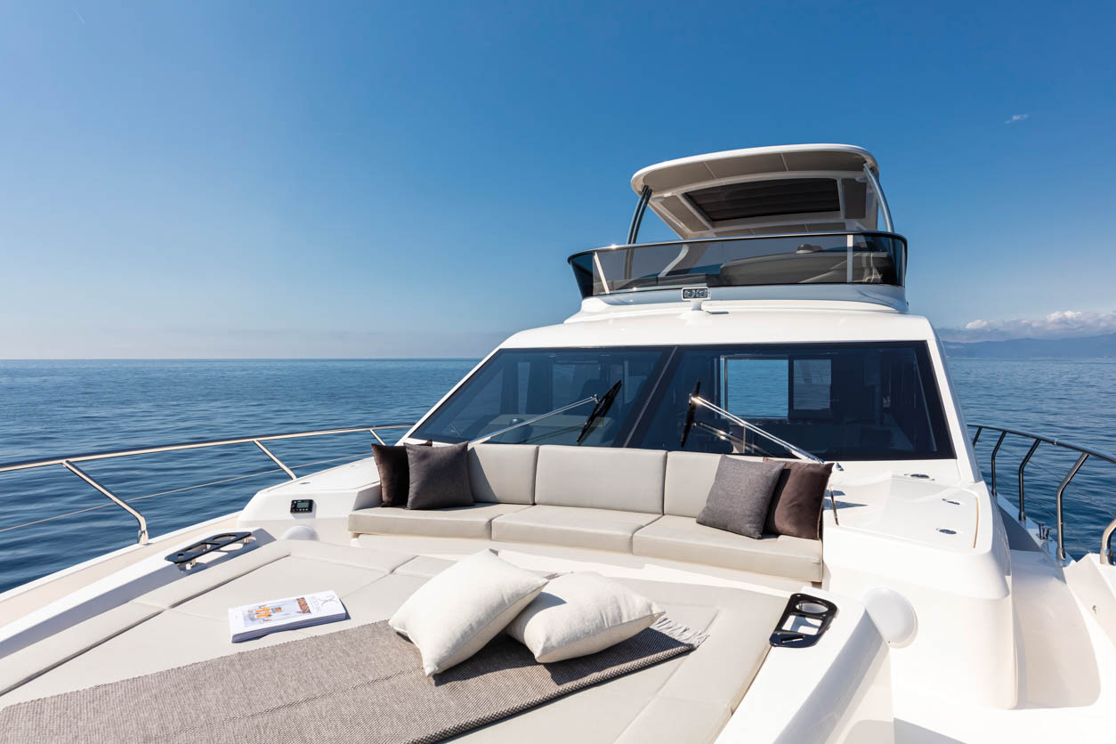 Absolute 62 Fly Emilia II yacht charter in Mallorca — anchored in a turquoise cove near Puerto Portals, from Marina Port de Mallorca, Palma.