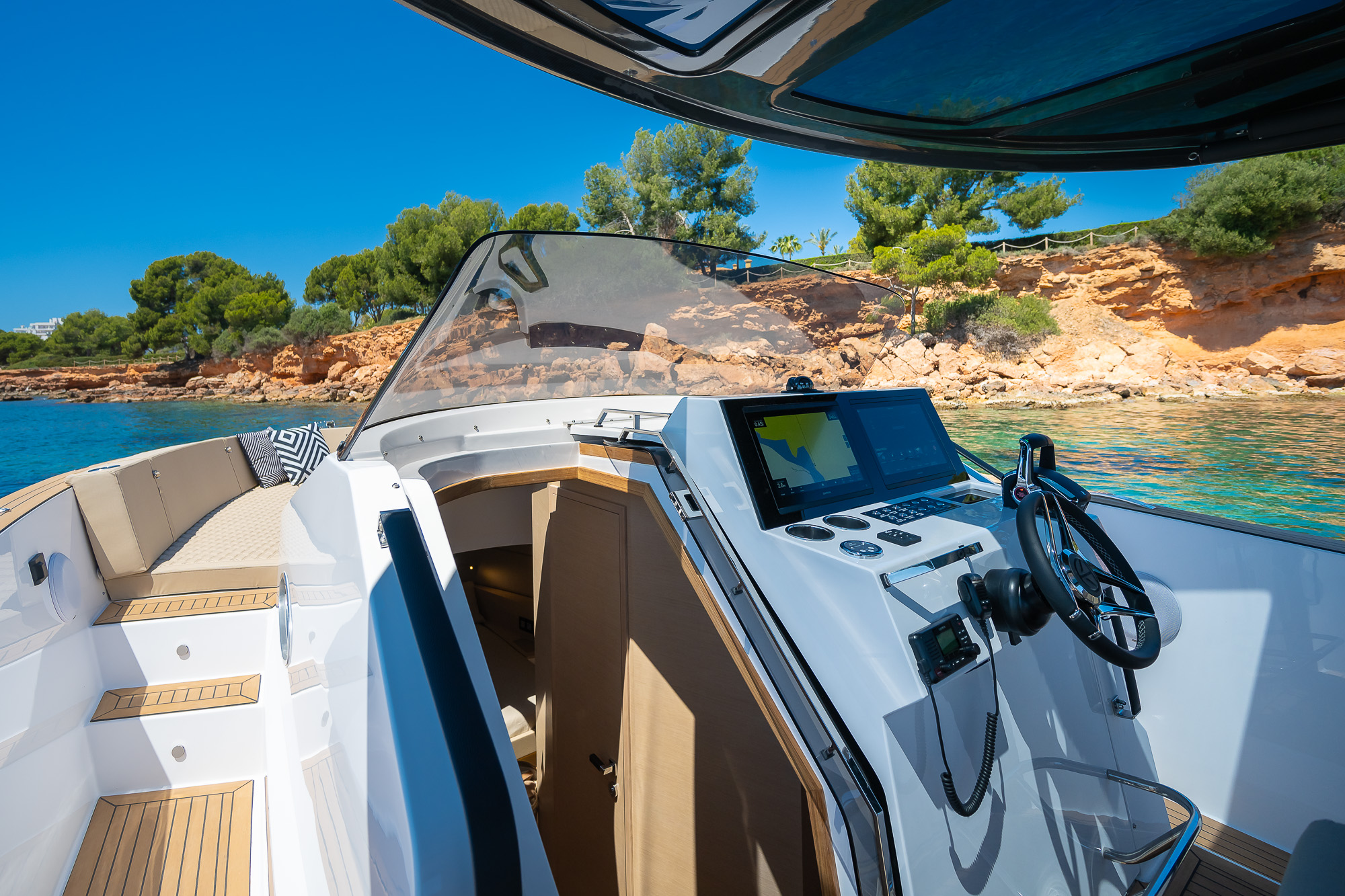Tesoro T40 GTS New 2026 yacht charter in Mallorca — anchored in a turquoise cove near Puerto Portals, from Puerto Portals.
