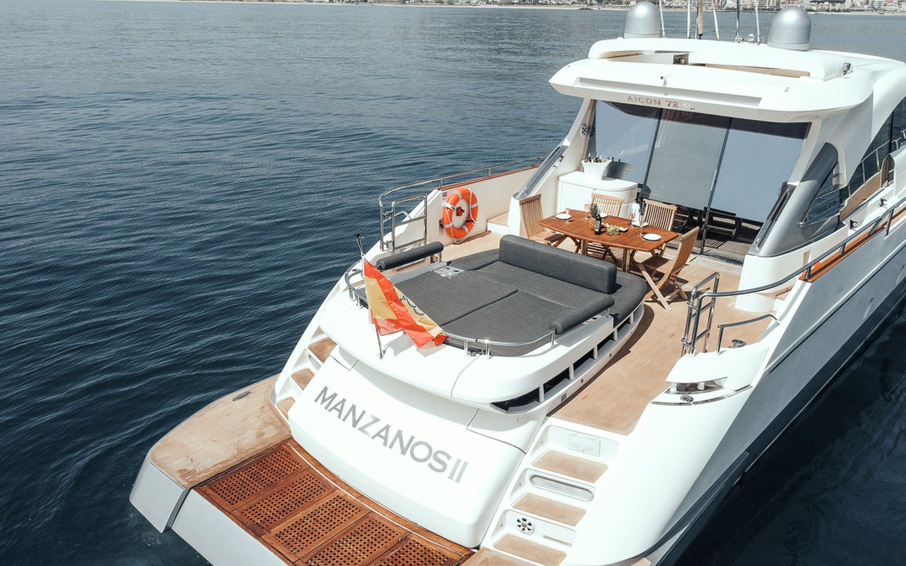 Aicon 72 SL Gadea yacht charter in Mallorca — cockpit lounge shaded for long Mediterranean lunches, from Marina Palma, La Lonja.