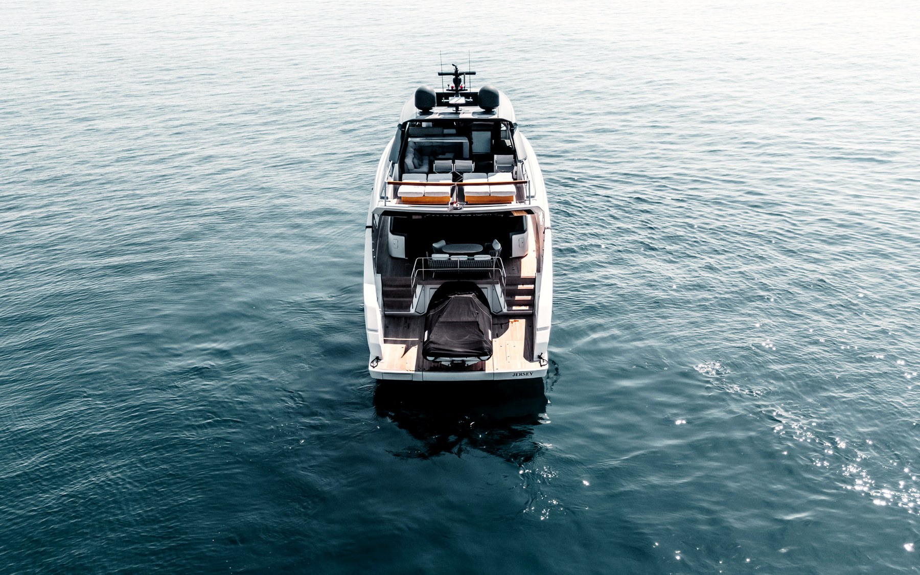 San Lorenzo SX76 Globito de Mar yacht charter in Mallorca — anchored in a turquoise cove near Puerto Portals, from Marina Port, Palma de Mallorca.