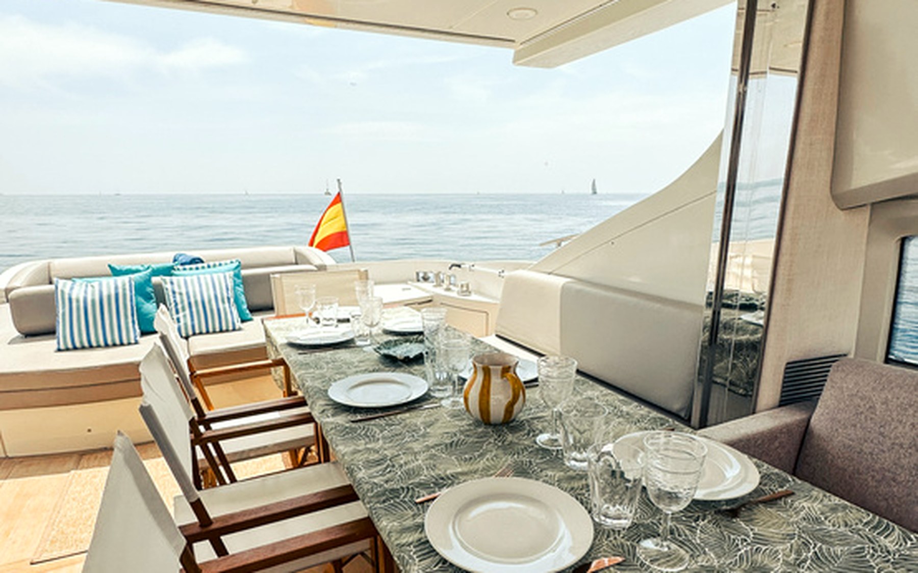 Azimut 68 S Esperanza yacht charter in Mallorca — cockpit lounge shaded for long Mediterranean lunches, from Marina Palma, La Lonja.