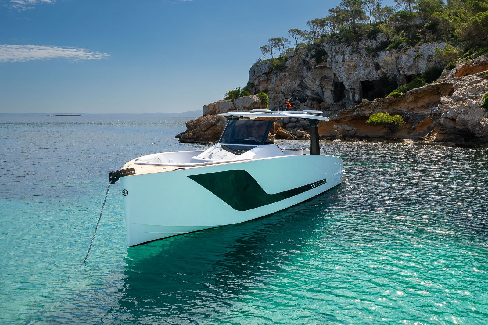 Tesoro T40 GTS New 2026 yacht charter in Mallorca — anchored in a turquoise cove near Puerto Portals, from Puerto Portals.